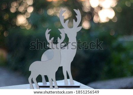 Two deer silhouettes, simple Christmas decoration. Selective focus, beautiful bokeh.