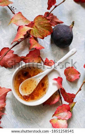 fresh ripe figs and fig jam on a light background, selective focus
