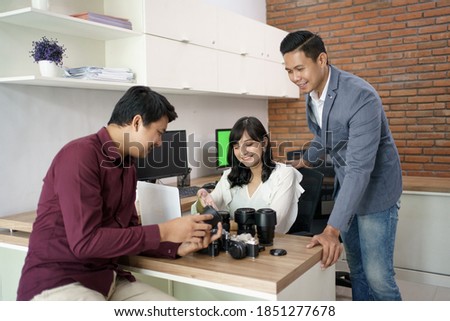 Portrait of a customer service explaining the product on camera equipment rental shop
