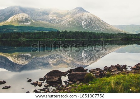 Beautiful Irish Landscape - Mountain and trees with perfect reflexion on the lake - Connemara, Ireland 2020