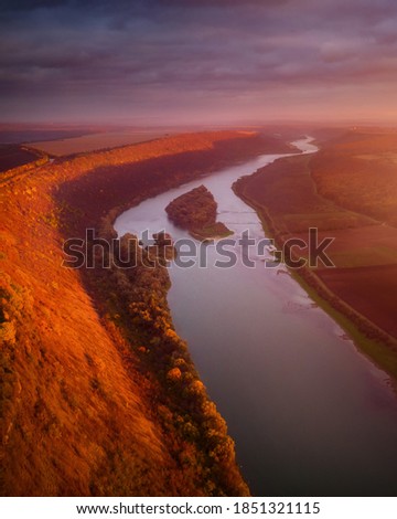 Beautiful top view of winding river in sunset. Scenic image of drone photography. Location place Dnister or Dniestr canyon, Ukraine, Europe. Picturesque wallpaper. Discover the beauty of earth.