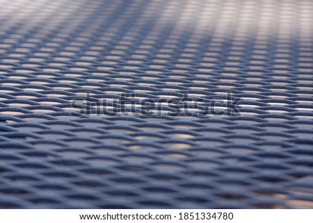 Closeup of the pattern on a metal outdoor table 