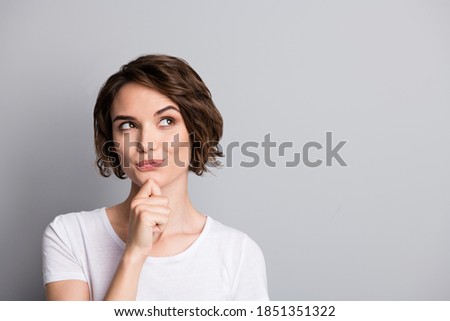 Portrait of young curious thoughtful beautiful girl woman female look in copyspace hold hand on chin isolated on grey color background Royalty-Free Stock Photo #1851351322