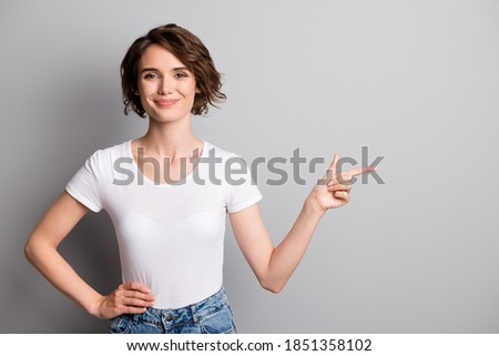 Photo of young beautiful woman show point index finger empty space advert promotion isolated over grey color background