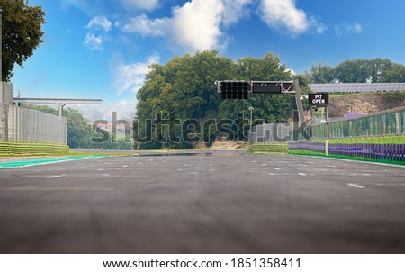 Pit open text banner on asphalt motor sport circuit starting line blue sky background