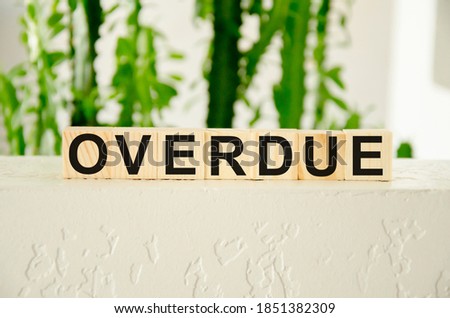 overdue invoices concept. word overdue written on wooden cubes. High quality photo