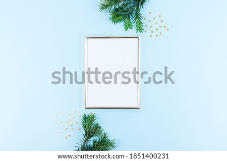Christmas theme minimalist picture frame. Frame surrounded with Christmas decorations. Flatlay minimal style.