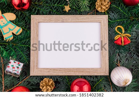 Flat lay minimal style. Christmas decoration with frame. Holidays theme photo.