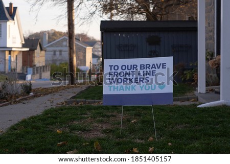 Lawn sign to our brave front line workers thank you in front of a house during corona virus pandemic outbreak quarantine. Emergency workers, first responders, health care workers appreciation concept.