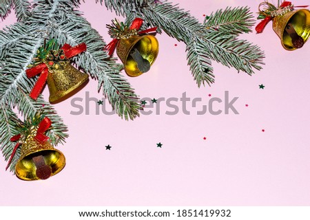 The snow branch of the Christmas tree, on a pink background with toys, Christmas tree jewelry. Christmas, winter, new year. Holiday card. The concept of celebrating Christmas. Copy Space.