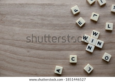 Top view of alphabet of words Win Win on wooden background.