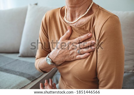 Upset stressed mature middle aged woman feeling pain ache touching chest having heart attack, sad worried senior older lady suffers from heartache at home, infarction or female heart disease concept Royalty-Free Stock Photo #1851446566