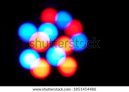 magic blurred BACKGROUND, Christmas design with colored: red, blue, yellow bokeh circles on a black background,