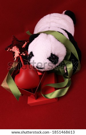 Panda Plush Doll with Christmas Ornaments for Decoration, Red Christmas Star, Green ribbon, Red Heart, Red background