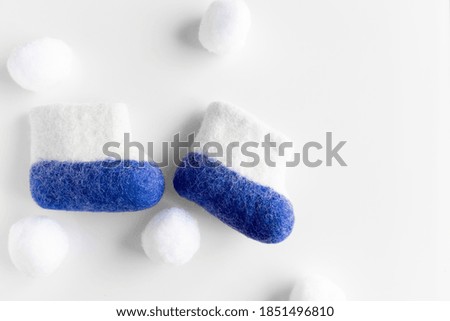 Felt boots, Snowballs on a White background. Card. Independence Day.