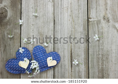 Pear tree blossoms with blue calico hearts border wooden background