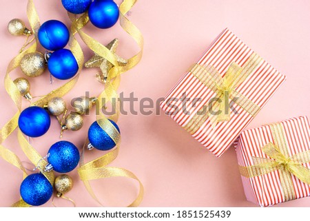 New Year's content with sprigs ate, gold toys for the Christmas tree. gift decorated with gold ribbon, the symbol of the new year 2021. Flat lay