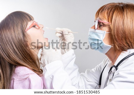 Coronavirus test - Medical worker taking a swab for corona virus sample from potentially infected child. covid-19 nasal swab test - doctor taking a mucus sample from patient nose in hospital Royalty-Free Stock Photo #1851530485