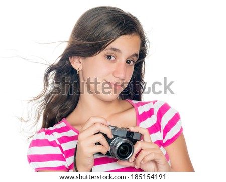Trendy young girl holding a vintage looking compact camera with her hair floating in the hair (isolated on white)