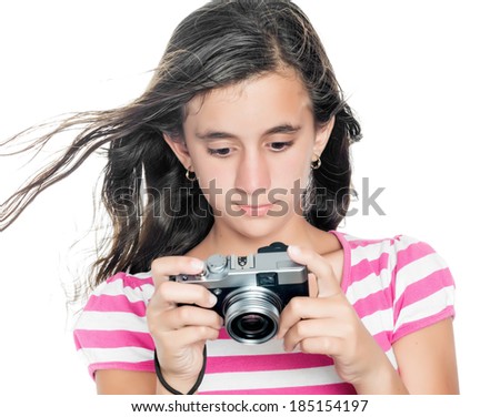 Cute young girl looking at images taken on a compact camera (isolated on white)
