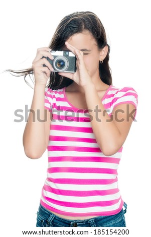 Cute young girl taking a photo with her hair floating in the air (looking through the viewfinder , isolated on white)