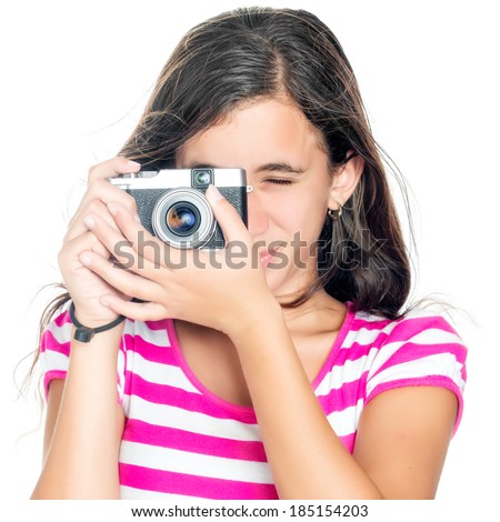 Beautiful young girl taking a picture with a vintage looking  compact camera looking through the viewfinder (isolated on white)