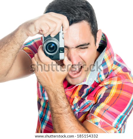 Man using a vintage looking compact camera with a funny surprise expression