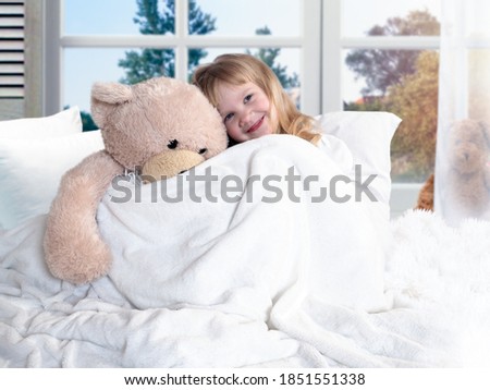 Happy awakening of a child with a favorite toy