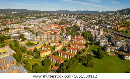 Oslo, Norway. Beautiful panoramic aerial view photo from flying drone for Oslo city new neighborhoods and new homes. Against the background of the mountains and blue sky on a sunny summer day.(Series)