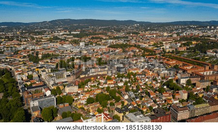 Oslo, Norway. Beautiful panoramic aerial view photo from flying drone for Oslo city new neighborhoods and new homes. Against the background of the mountains and blue sky on a sunny summer day.(Series)