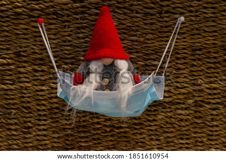 new year gnome in a medical mask