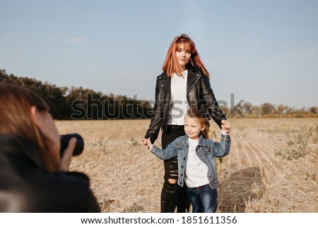 Daddy taking pictures of his family. Young man photographing his wife and little daughter for family blog. Modern parents, child, blogging, photography, childhood, parenthood, family bonds concept