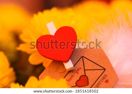 Valentine's Day Love Confession Letter and a bouquet of yellow chrysanthemums, blurred background