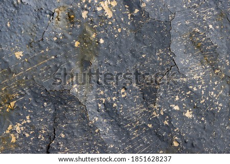Peeling paint on the wall. Old rusty metal with cracked flaking enamel. Weathered rough painted surface with patterns of cracks and peeling. Grunge texture for background and design. High resolution.