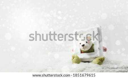 Toy teddy looking through empty picture frame.Merry Christmas and happy new year concept background.