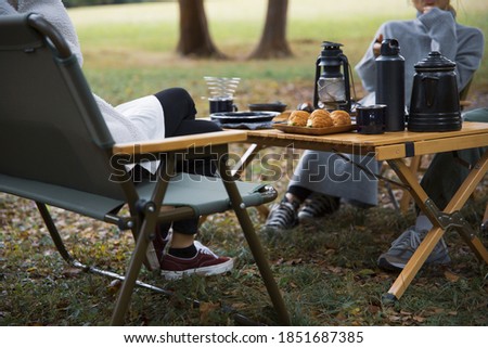 Image photo of women having lunch at a campsite