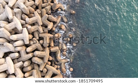 Aerial drone view of a breakwater. breakwater in the sea, a collection of concrete breakers Royalty-Free Stock Photo #1851709495