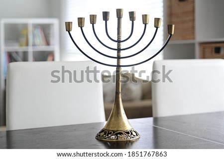 Menorah candelabra on a table in a Jewish Home. Menorah  is the national symbol of Israel State
