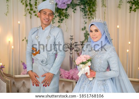 Indoor shooting for Malay wedding, the bride and groom wearing Malay traditional  cloth in marriage ceremony . Happy & Family Concept
