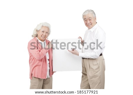 	Senior couple holding white board	