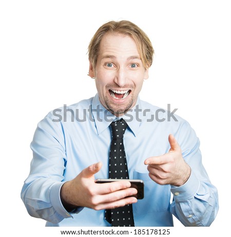 Closeup portrait, surprised, shocked happy young man, student excited by what he sees on his cell phone, isolated white background. Positive human emotions, facial expression, feelings, reaction