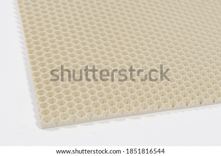 eva rug car mat cloth close-up macro photography of beige color background texture corner on white background honeycomb shape