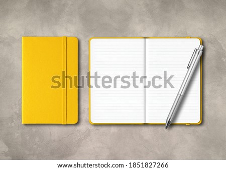 Yellow closed and open lined notebooks with a pen . Mockup isolated on concrete background