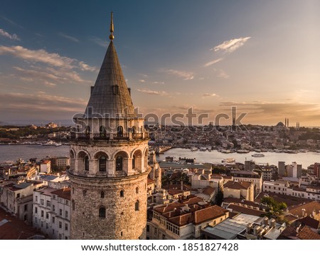 Aerial evening shot of the Galata Tower in Istanbul, Turkey. Aerial view of landmark at golden hour with beautiful sunlight. Royalty-Free Stock Photo #1851827428