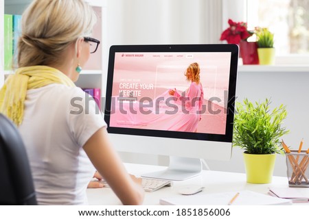 Woman creating her own website on computer Royalty-Free Stock Photo #1851856006