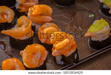 close up of sashimi sushi set with chopsticks and soy - sushi roll with salmon and sushi roll with smoked eel selective focus