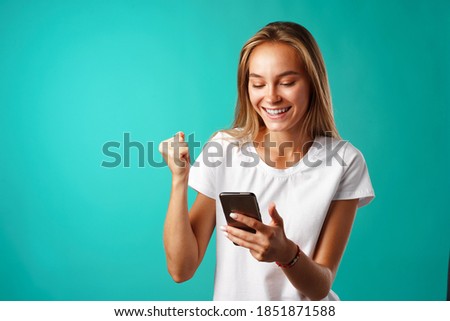 Young blonde casual girl using her smartphone.