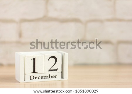 December 12 according to the wooden calendar .Winter day, empty space for text.Calendar for December on a light background.