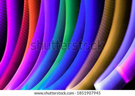 Wallpaper with bright curved lines multicolor. Background with copy space for screen or banner text. Lightpainting effect