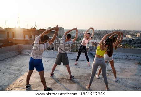 Portrait of smiling fit happy people doing power fitness exercise
